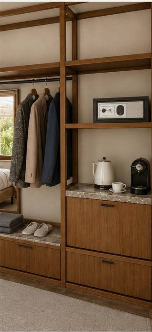 An open walnut wardrobe with marble tops, a kettle and a safe